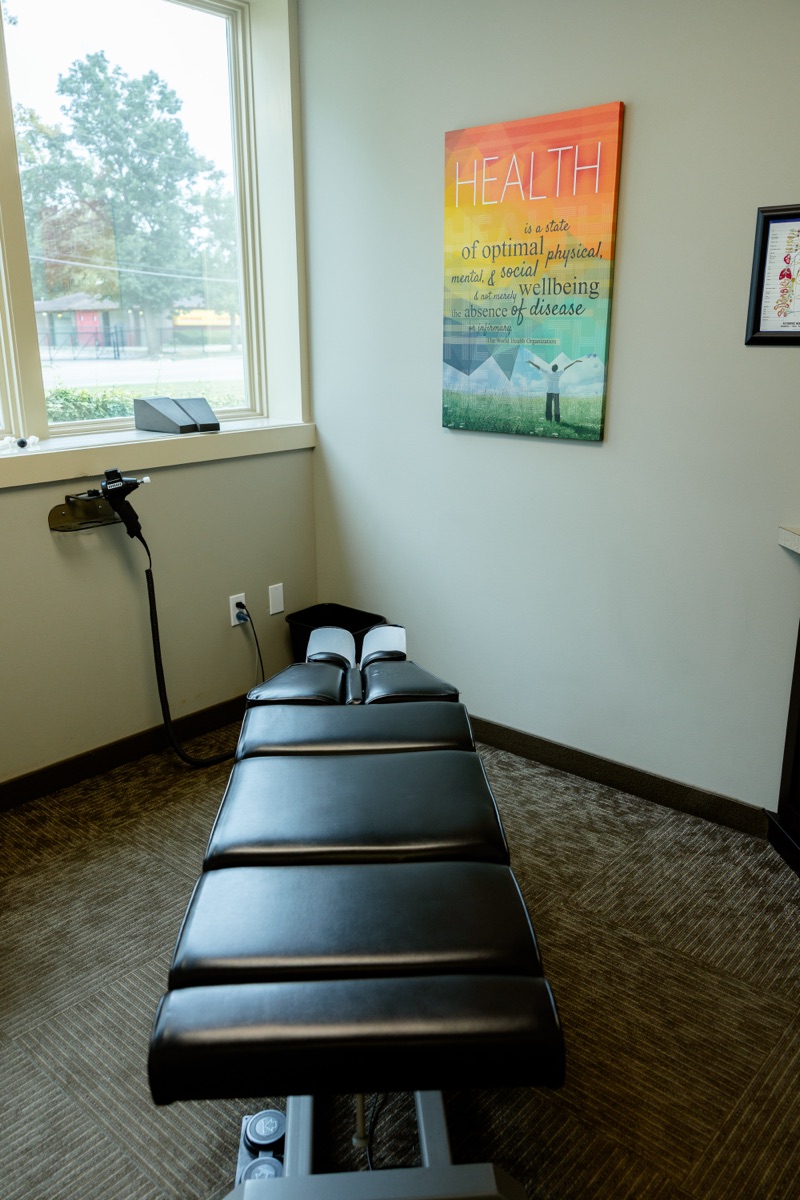Private adjustment room with treatment table and natural window light